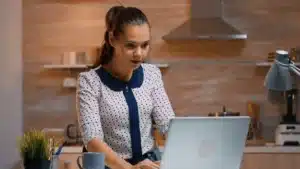 femme travaillant sur un ordinateur portable dans une cuisin